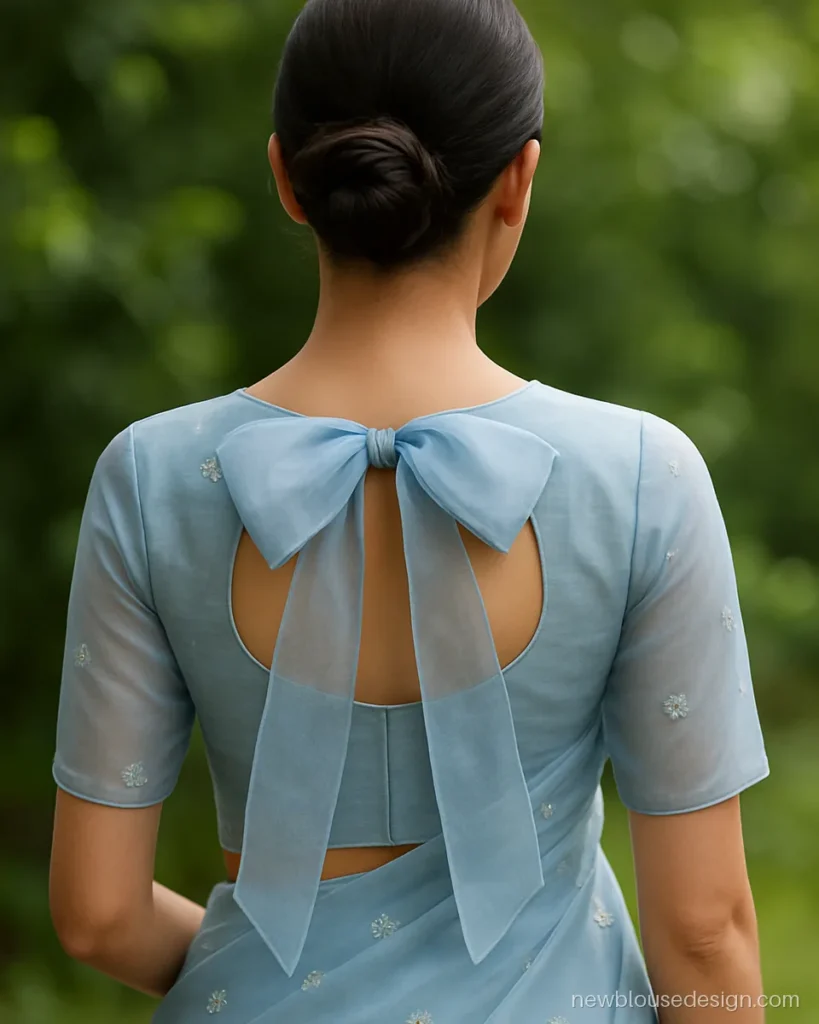 Powder blue organza blouse back with a big bow dori at the nape