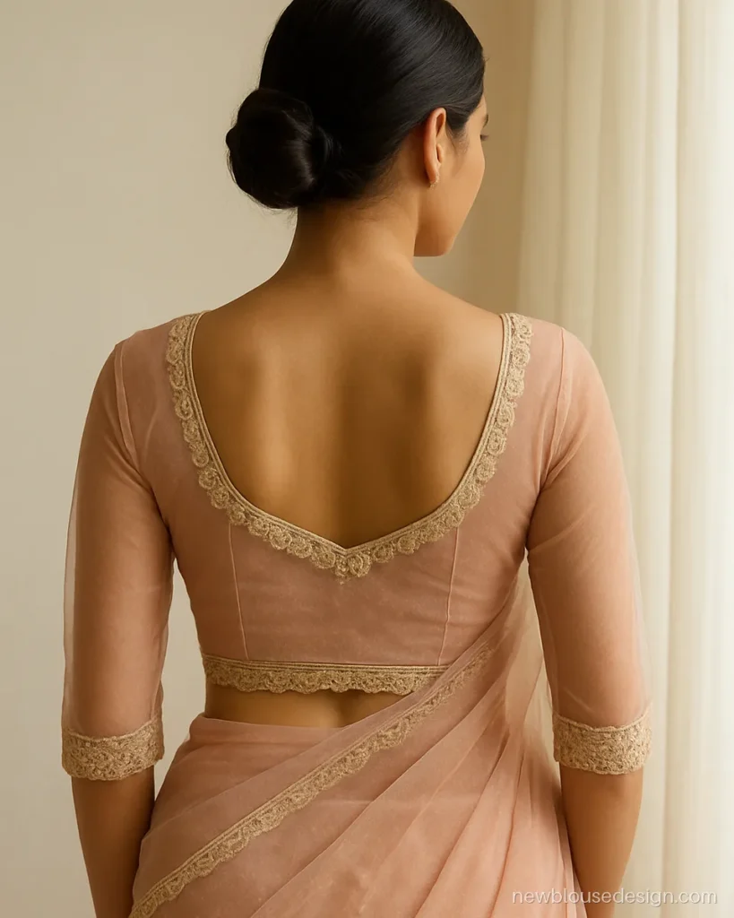 Blush pink net blouse back design with a scalloped lace edge on a deep U