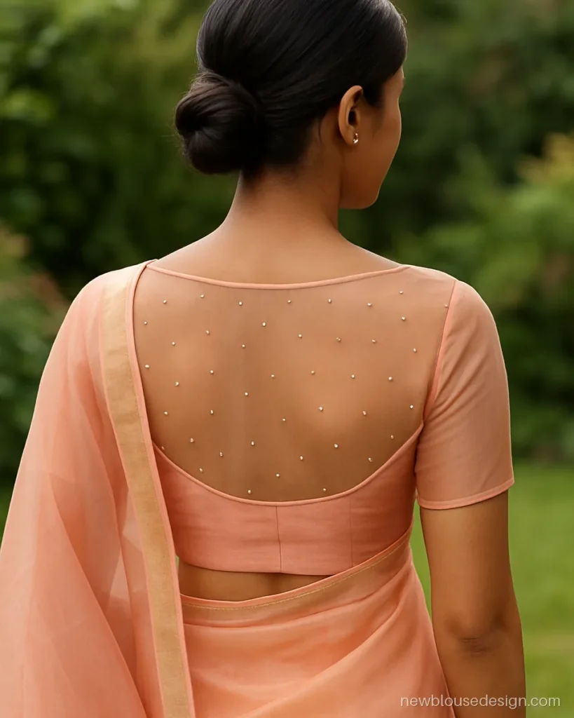 Peach organza backless blouse design for saree with a pearl net yoke