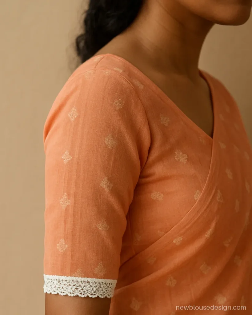 Jamdani blouse design with lace: peach sleeves with woven motifs and cotton lace edge