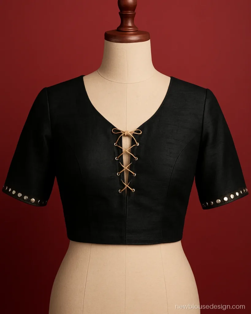 Black blouse with a laced V front and gold dori