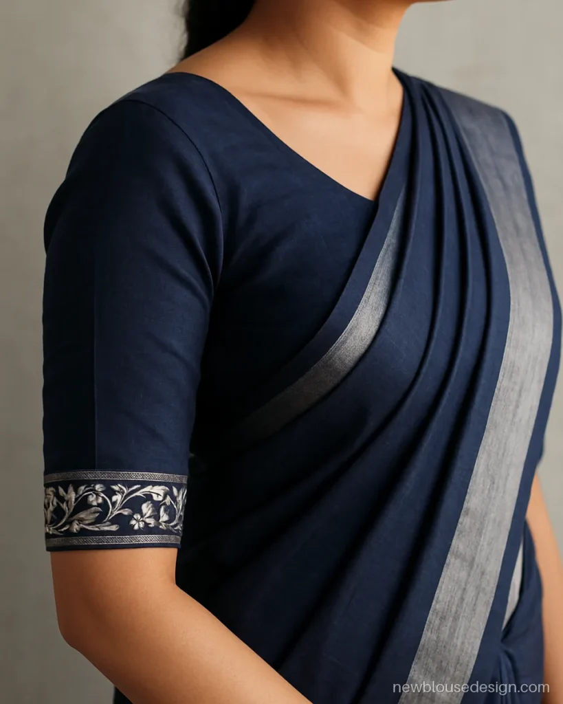 Navy blouse sleeve with a machine embroidery border on three quarter sleeves