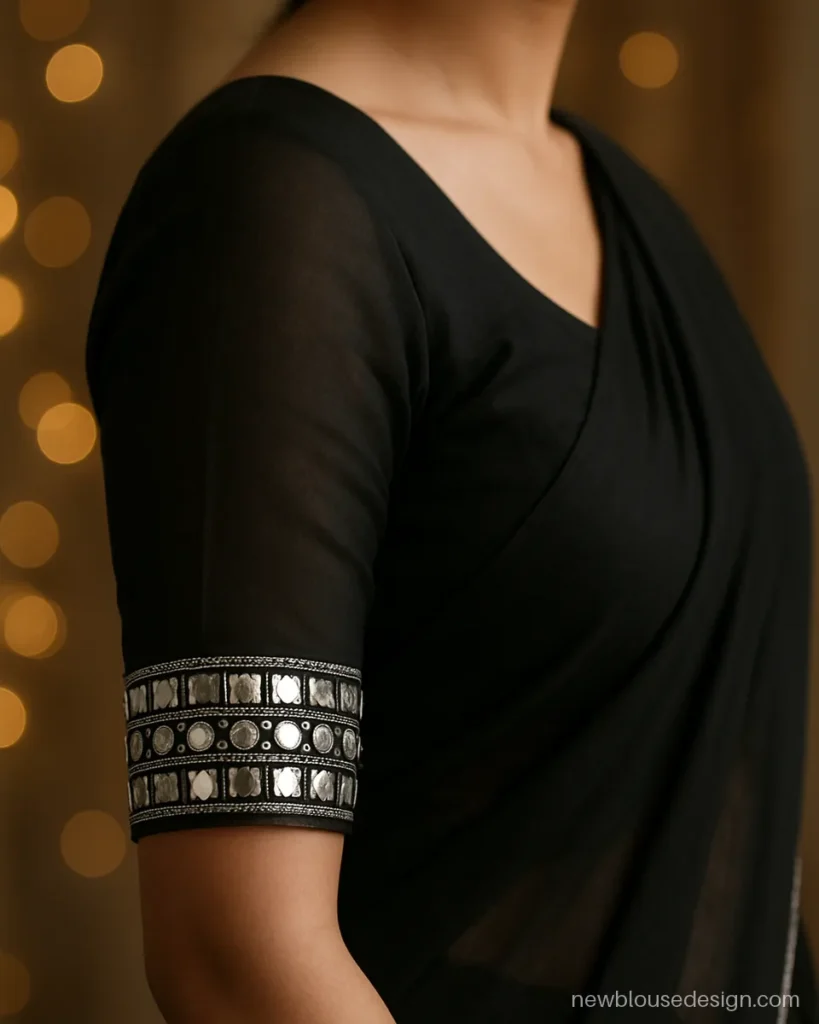 Black georgette blouse sleeve with a wide mirror work band at the elbow