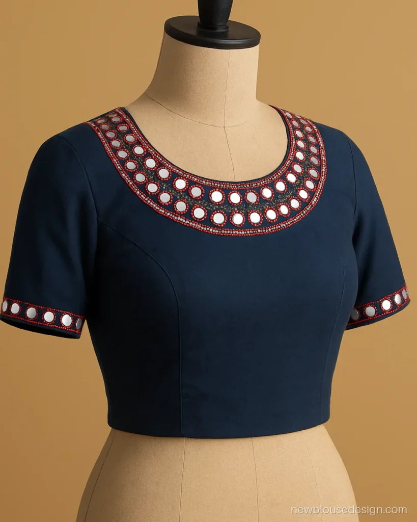Front side blouse design with a mirror work half moon yoke in indigo cotton