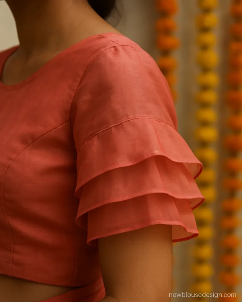 Coral organza blouse with three tier frill sleeves