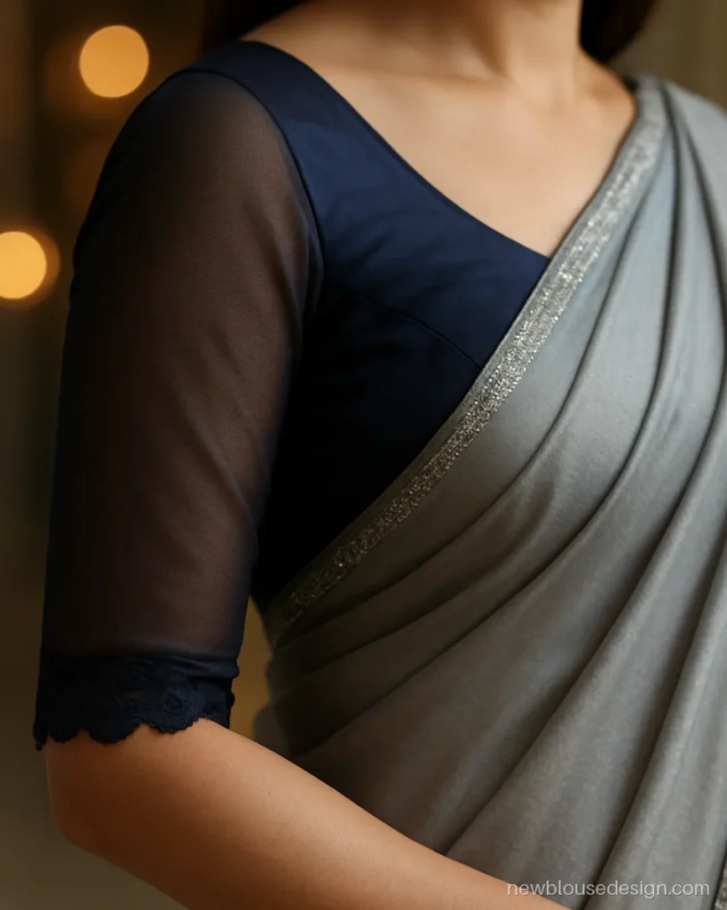 Sheer net sleeves on a navy silk blouse with scalloped lace edges