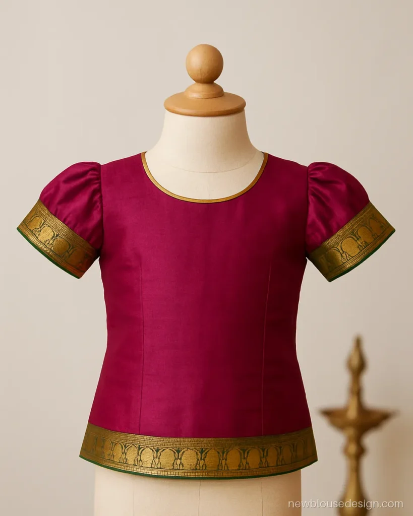 Kids pattu pavadai blouse design in magenta silk with temple border puff sleeves