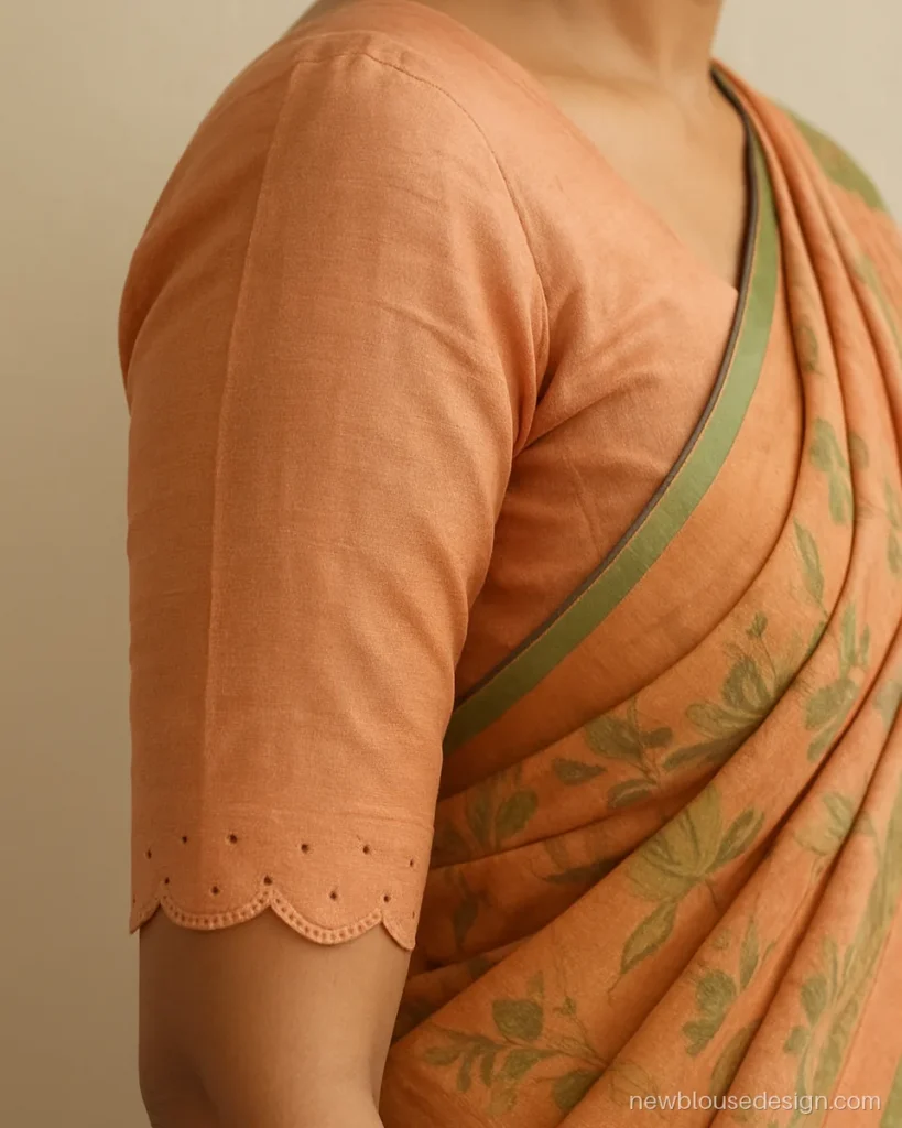 Peach blouse with scalloped elbow sleeves and small cutwork dots