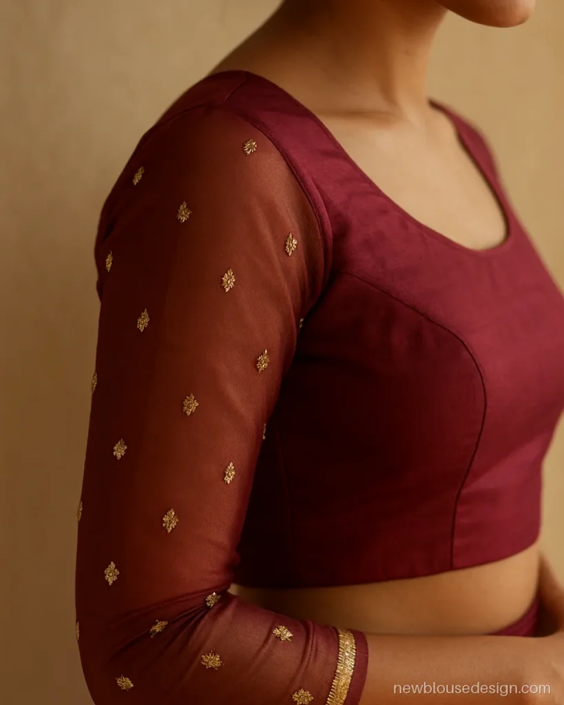 Maroon lehenga blouse with full sheer net sleeves scattered with gold buti