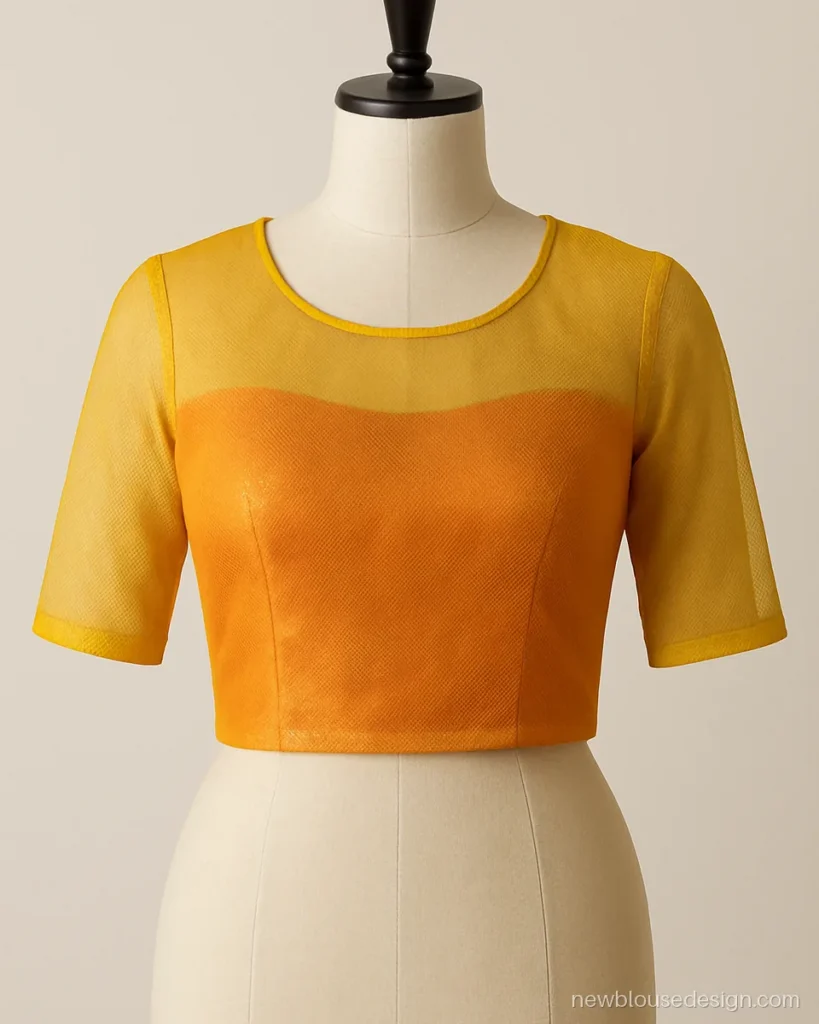 Yellow net blouse with contrast orange lining showing through the sheer net
