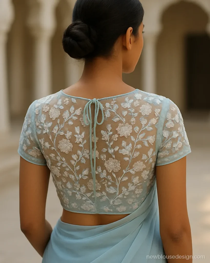 Stylish fancy net blouse design back with powder blue thread floral embroidery