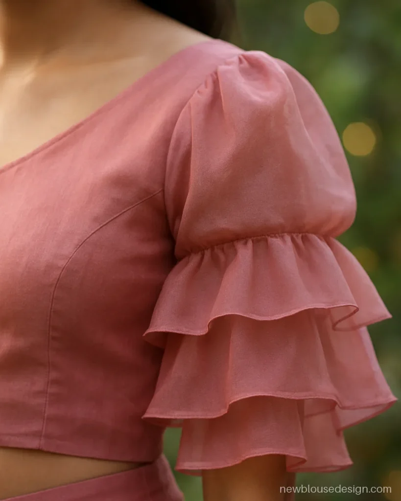 Frill one shoulder blouse in rose pink organza with a puffed single sleeve