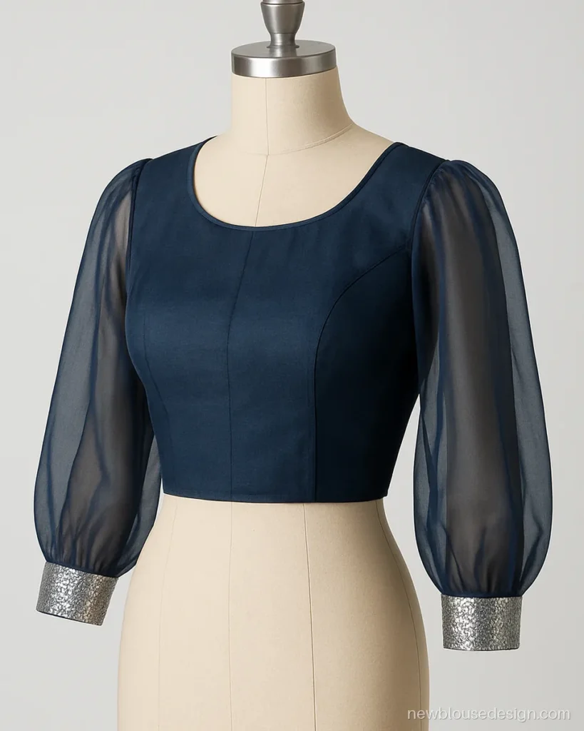 Navy organza blouse with full bishop sleeves gathered into a sequin cuff