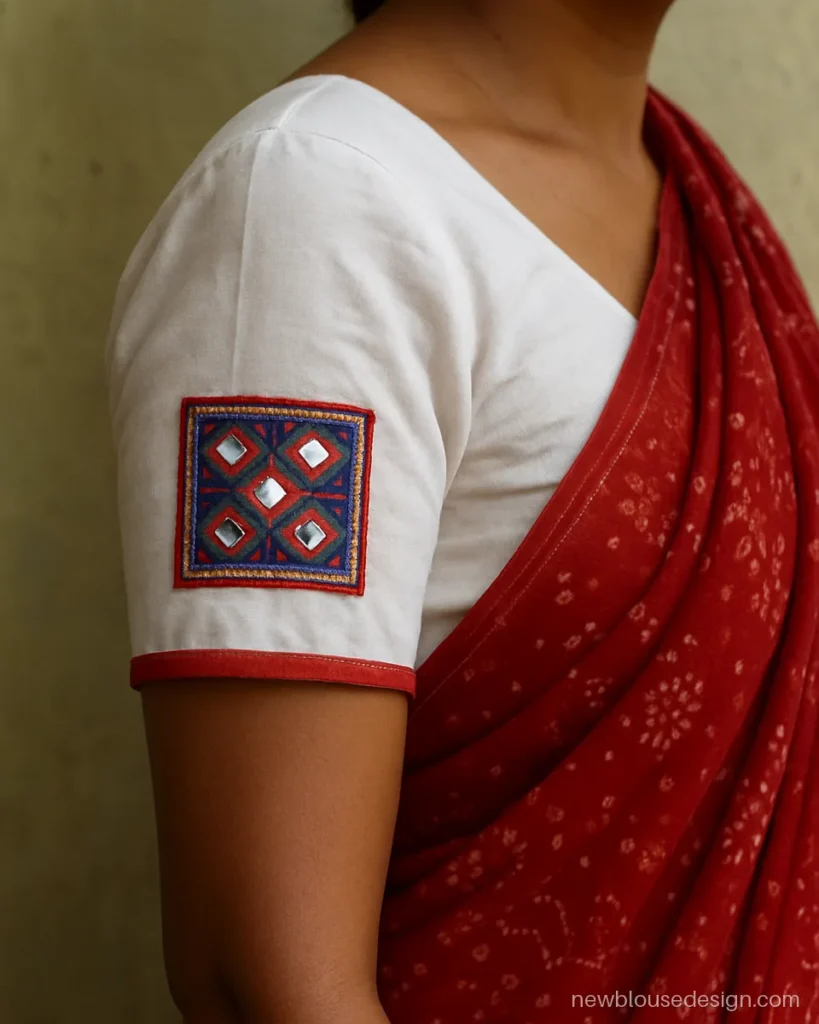 White cotton blouse with Kutch embroidery patches on short sleeves