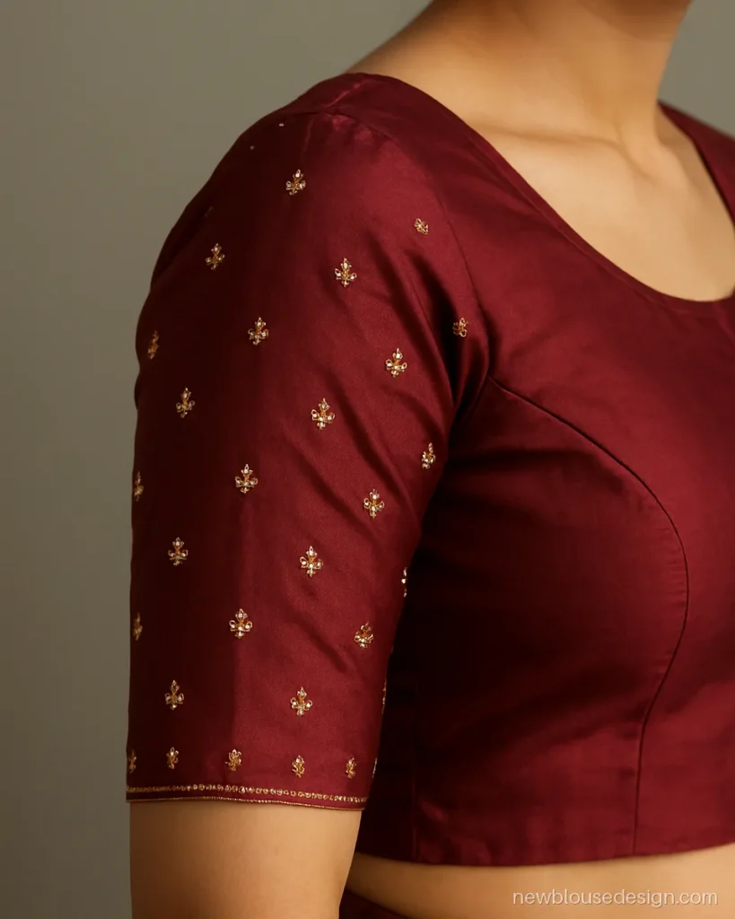 Maroon silk blouse with small aari butis scattered on elbow sleeves