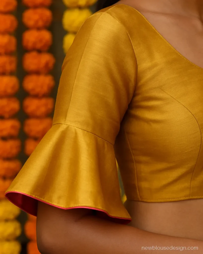 Short bell sleeves on a mustard silk blouse with a pink contrast lining