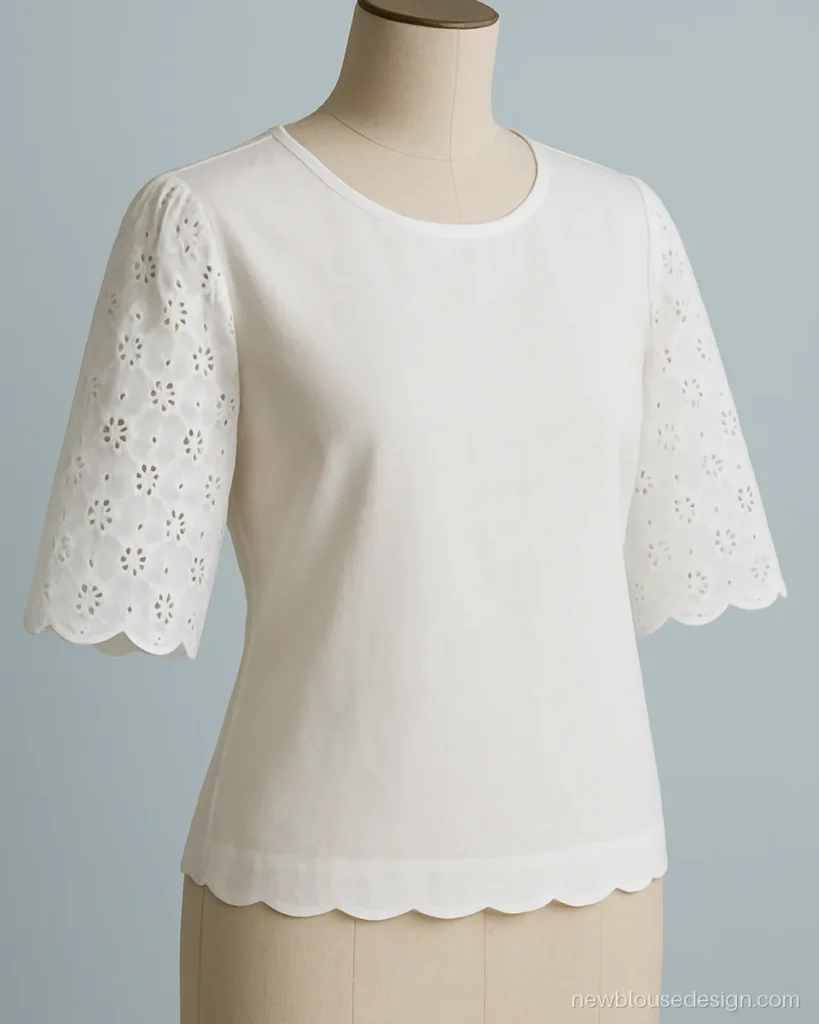 White cotton blouse with elbow sleeves in eyelet cutwork and a scalloped edge