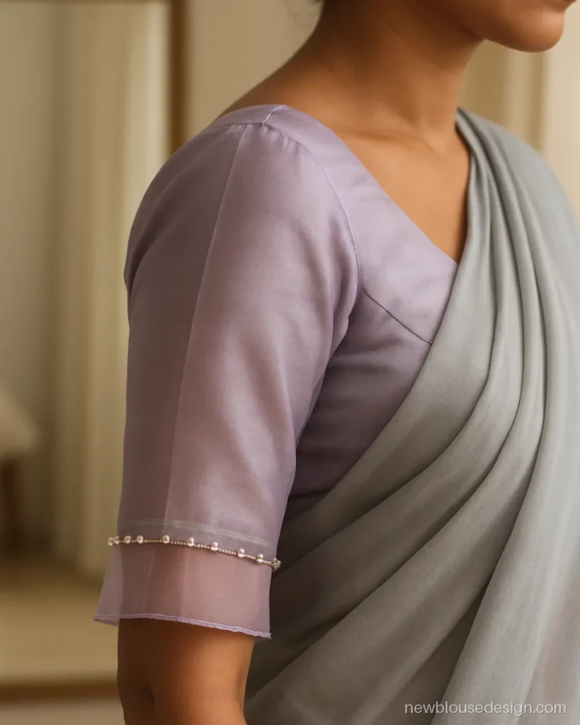 Lilac blouse sleeve with a sheer organza layer over a short silk sleeve and pearl edge