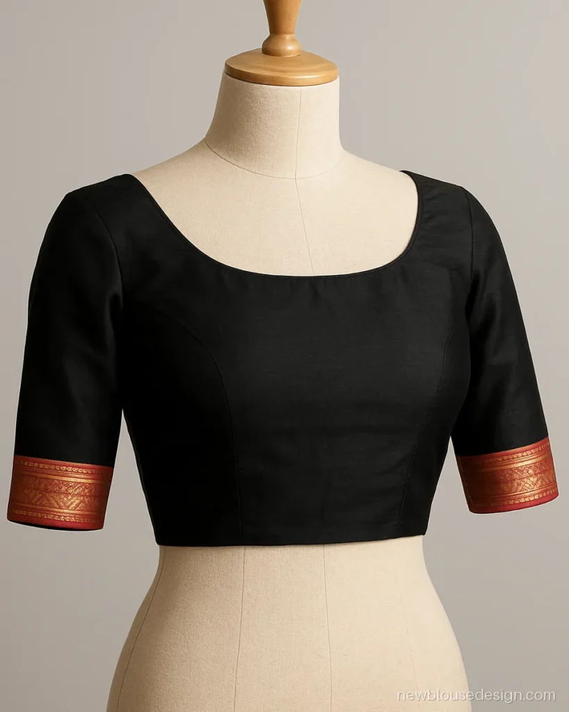 Black blouse with red temple border on a boat neck and sleeves