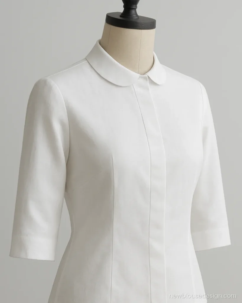 White cotton poplin office blouse with small collar and three-quarter sleeves